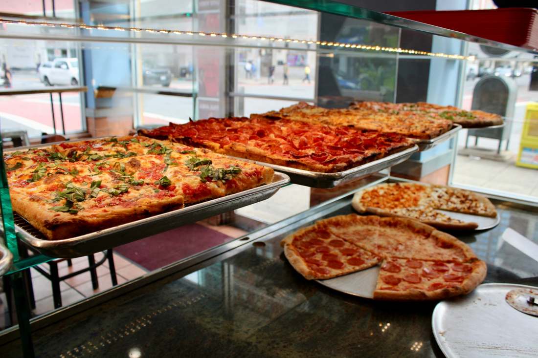 Fresh pizza trays in the display counter